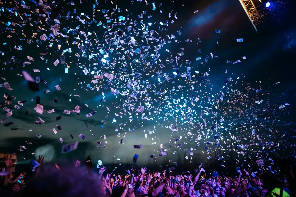 Público em evento com iluminação de palco